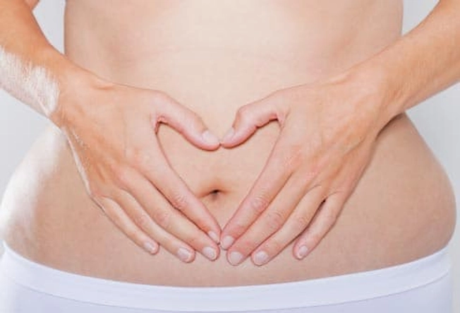 getty_rf_photo_of_womans_hands_on_stomach